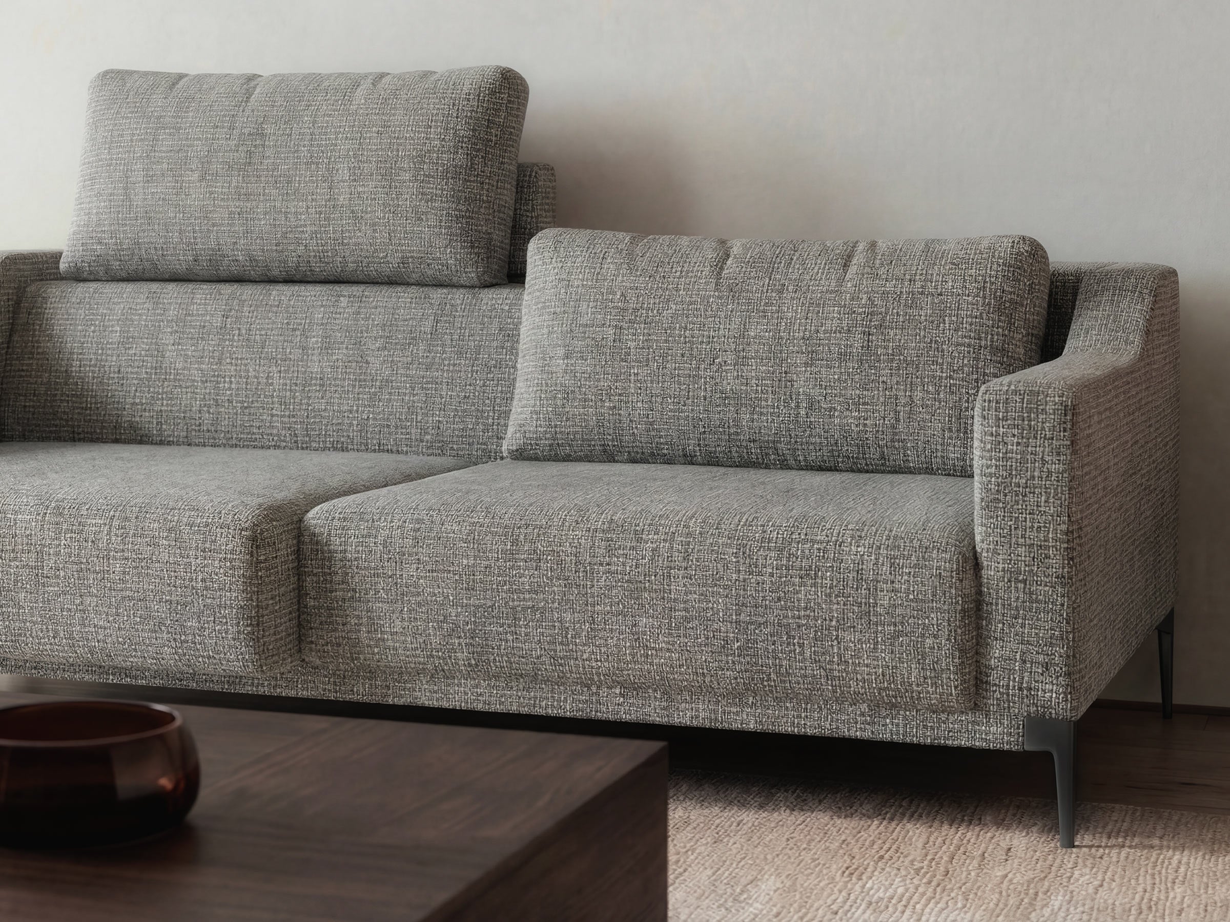 Gray textured sofa in a minimalistic living room setting.