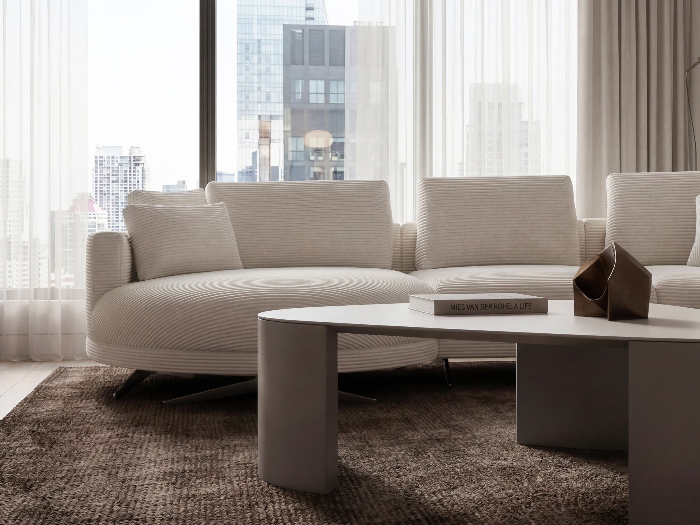 Modern living room with a beige sectional sofa and coffee table.