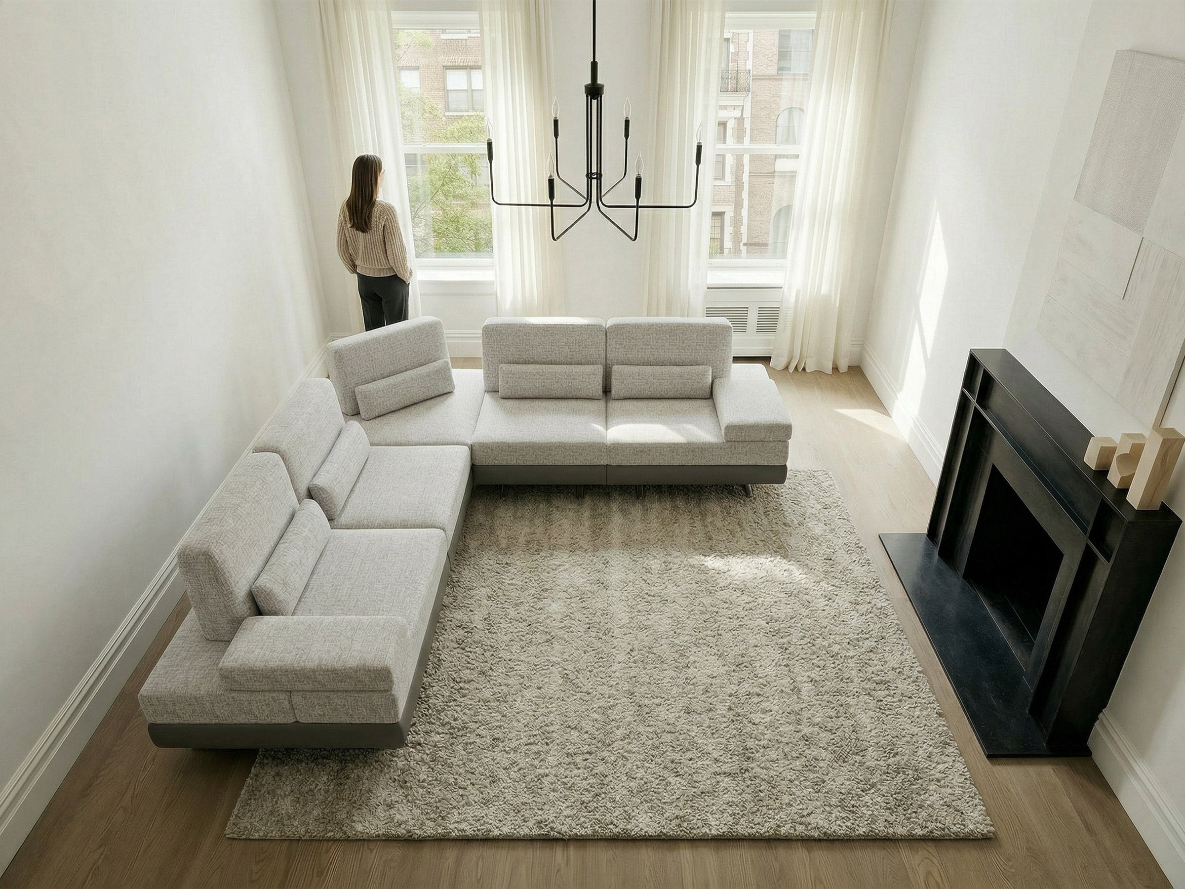 Modern living room with a gray sectional sofa, rug, and television.