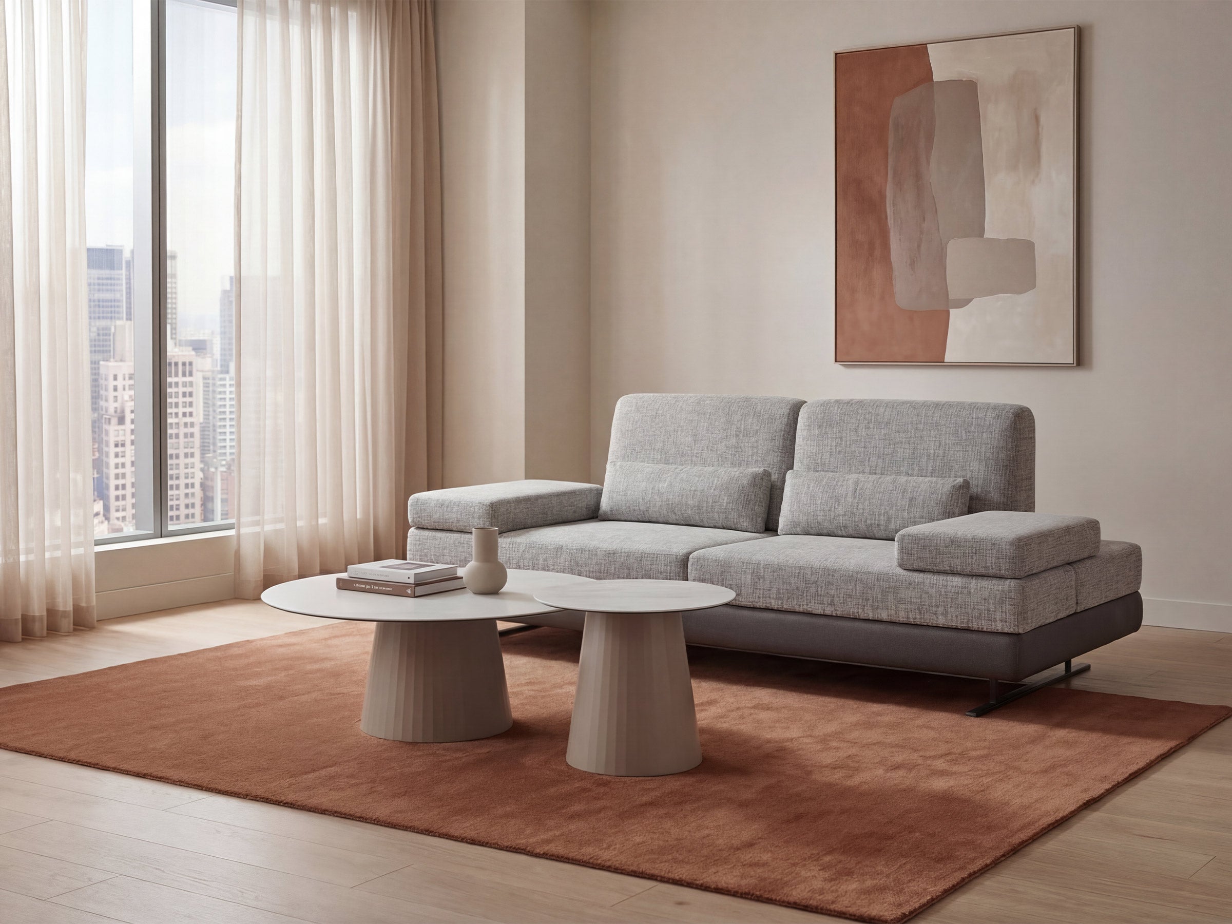 Modern living room with a gray sofa, coffee table, and abstract painting.