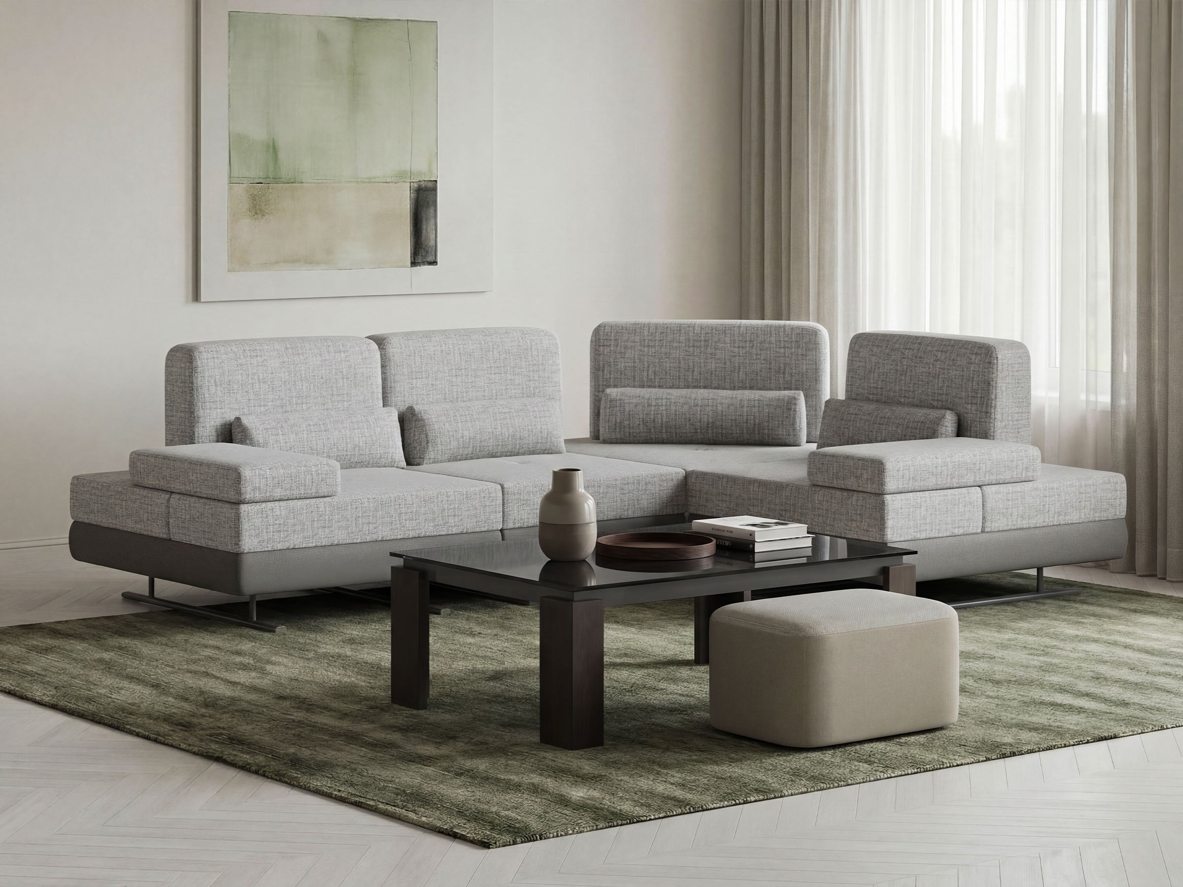 Modern living room with a gray sectional sofa, coffee table, and decorative items.