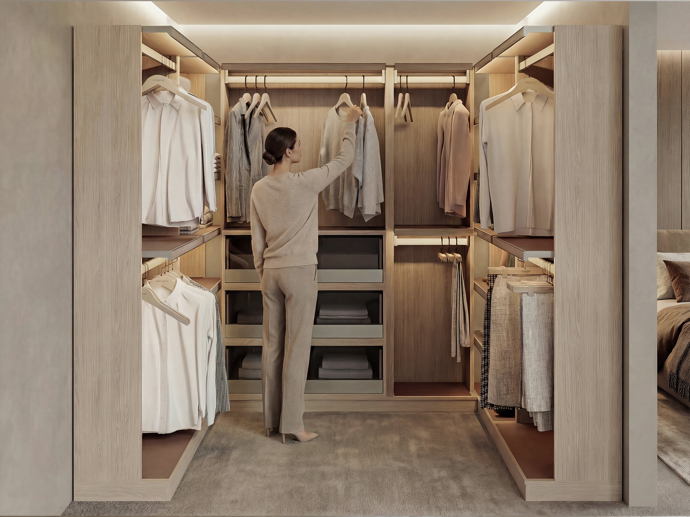 Person organizing clothes in a modern walk-in closet.