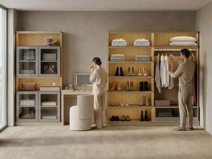 Modern walk-in closet with wooden shelves, clothes, and a desk.