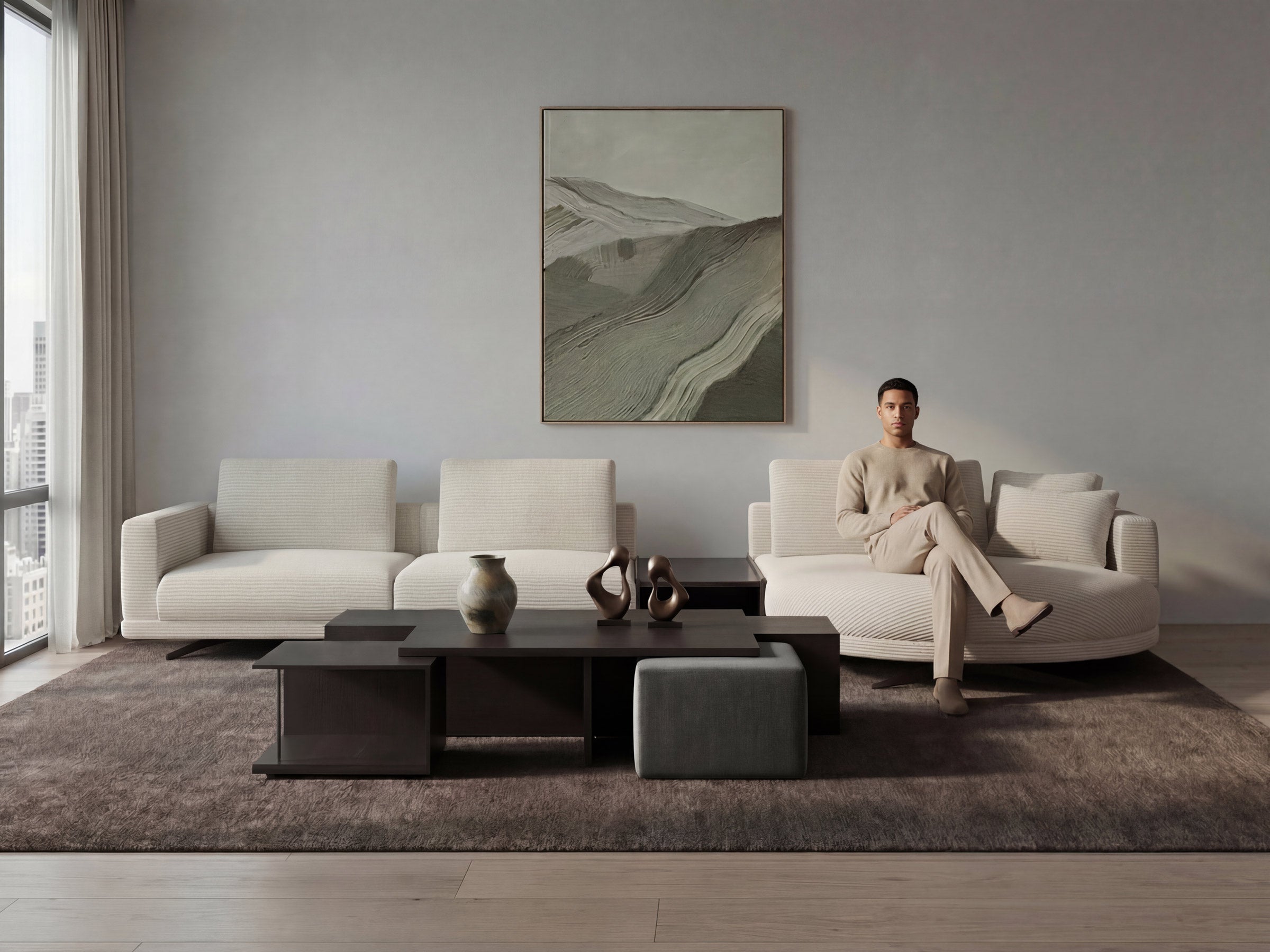 Person sitting on a modern sofa in a minimalistic living room with a large window.