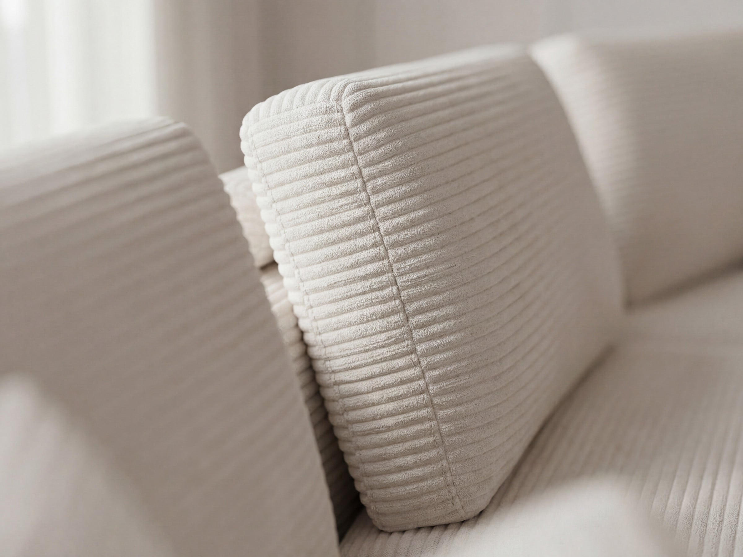 Close-up of a beige textured sofa corner
