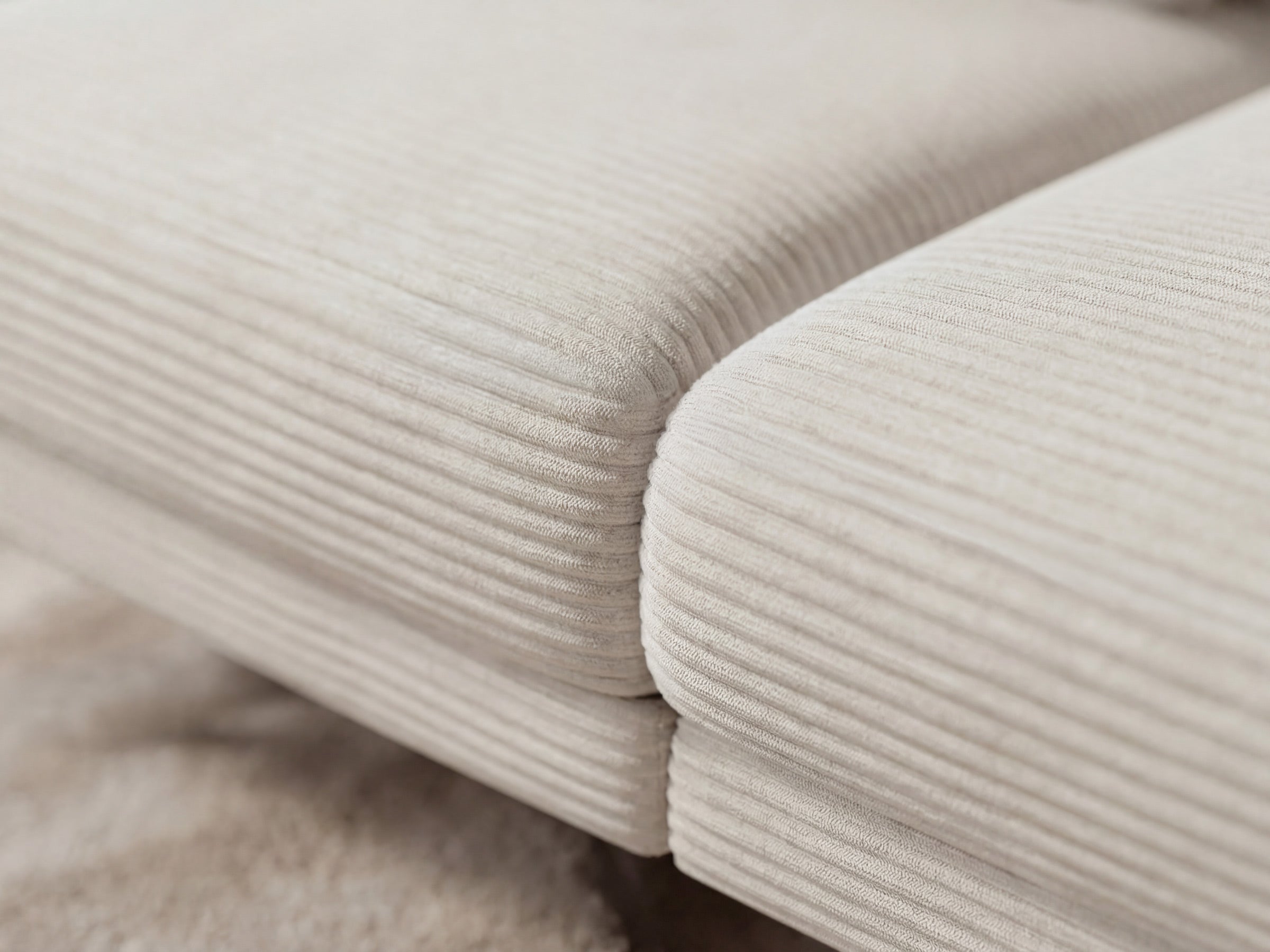 Close-up of beige corduroy fabric with a soft texture