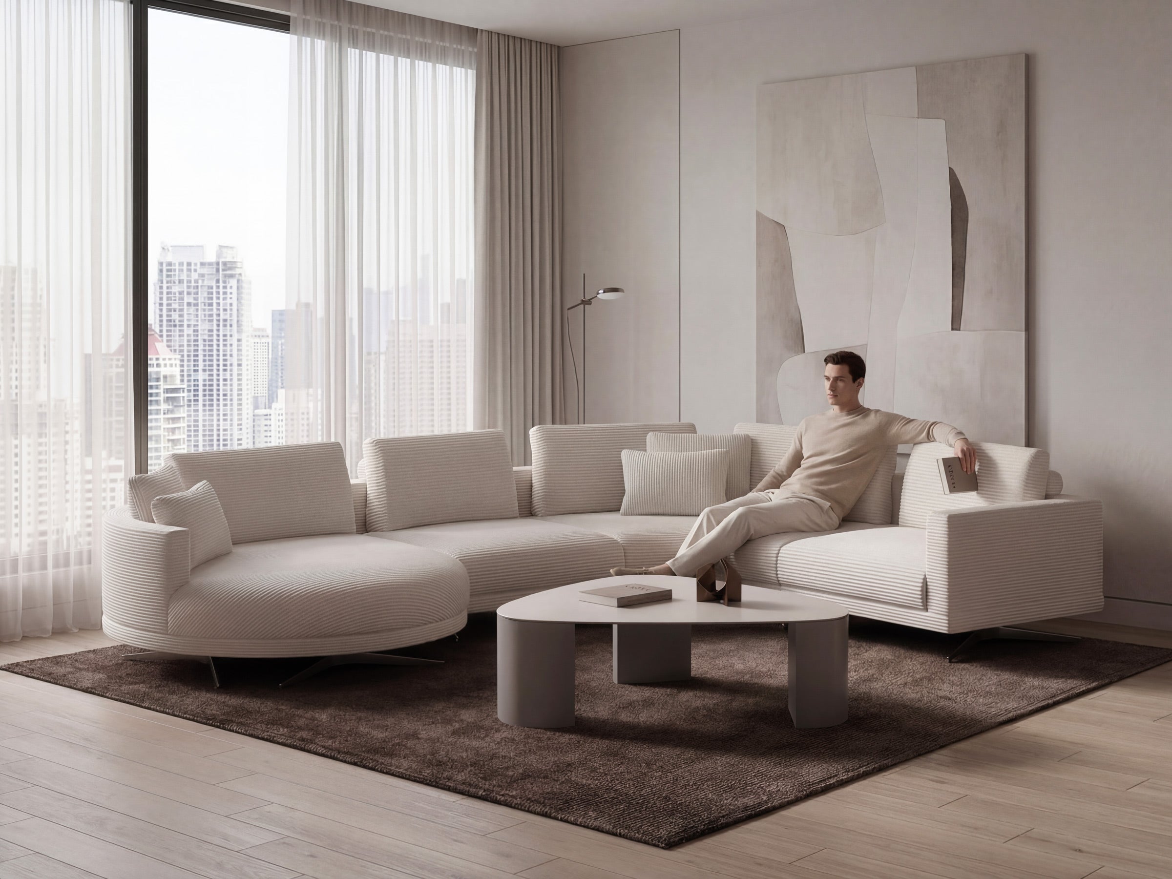 Man sitting on a modern white sofa in a stylish living room with large windows.