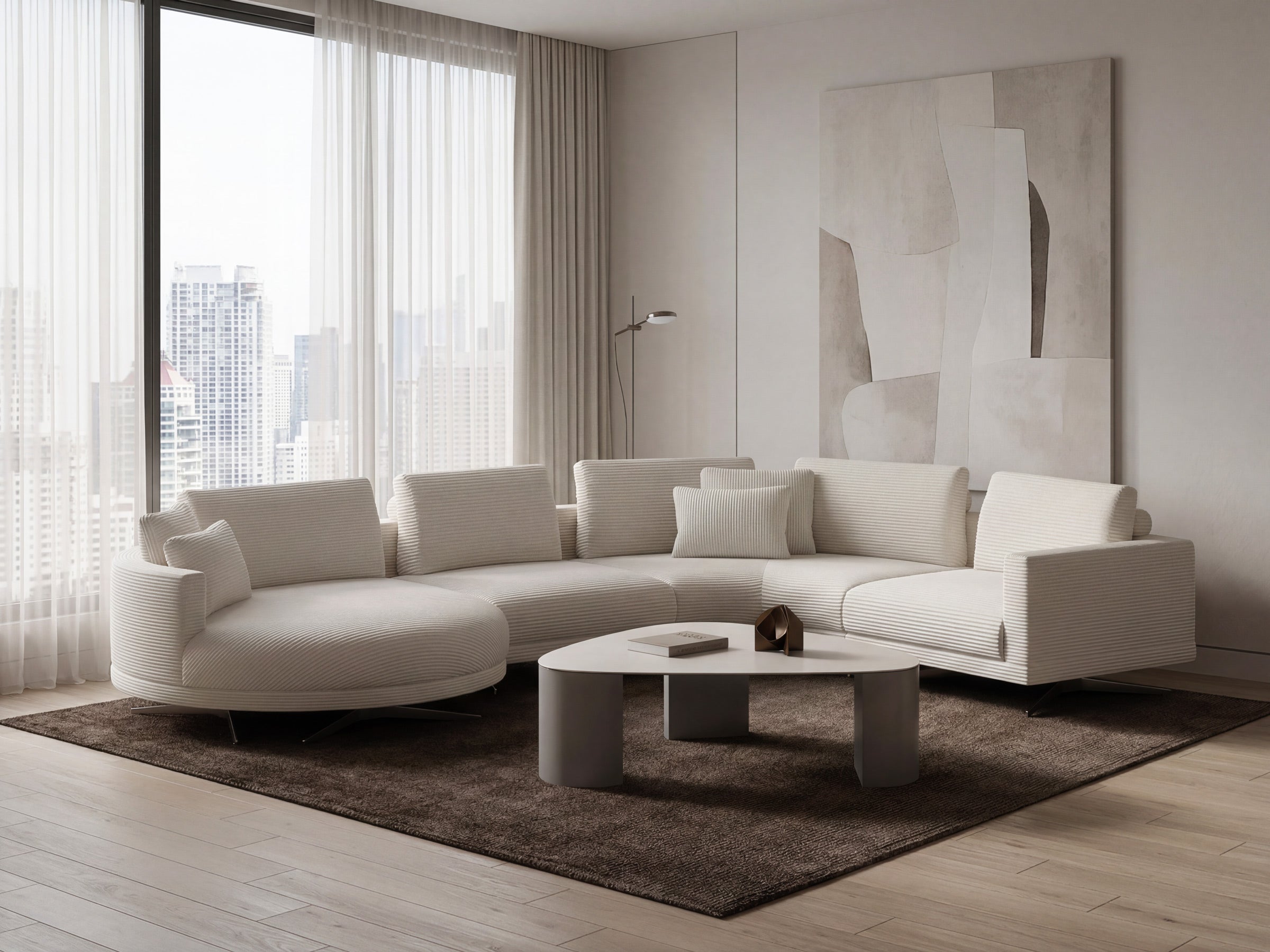 Modern living room with a white sectional sofa, coffee table, and abstract art on the wall.
