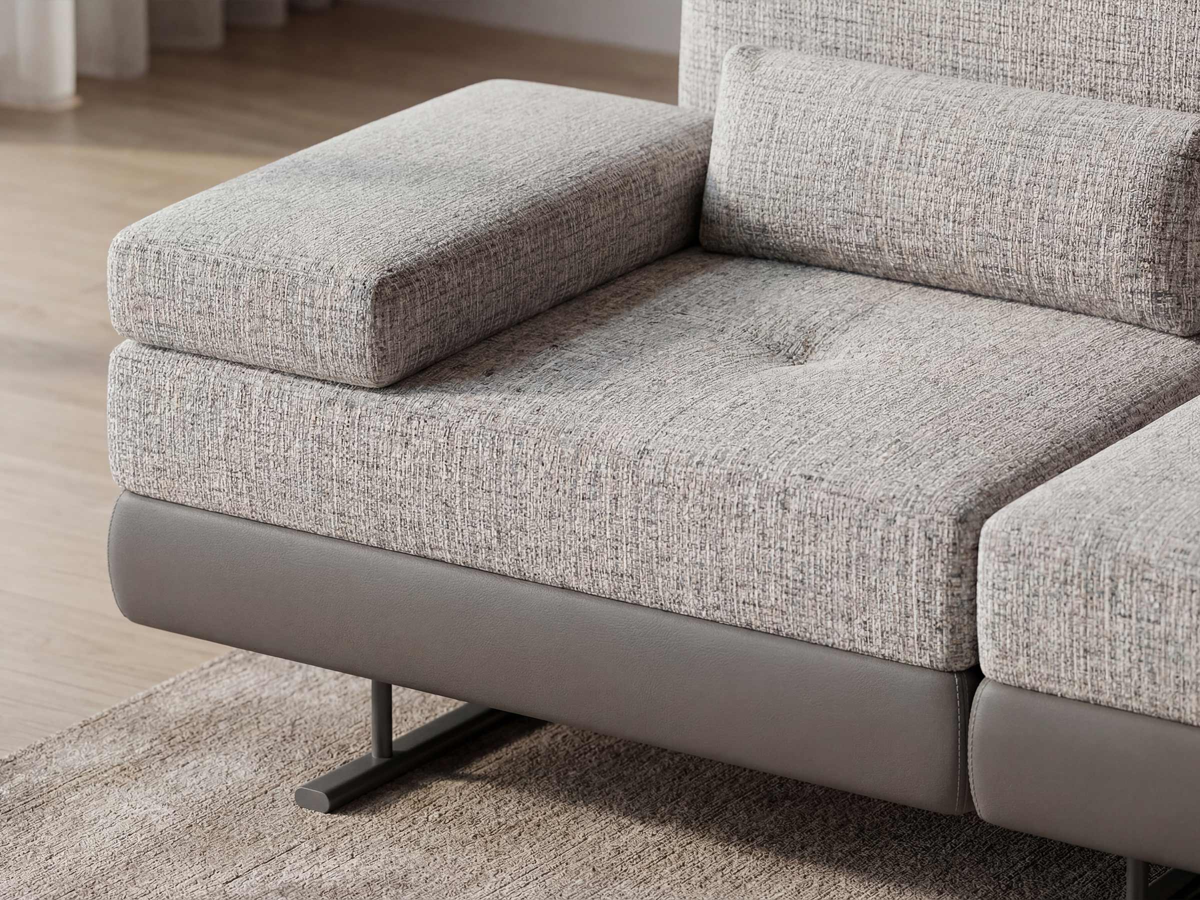 Gray fabric sectional sofa on a wooden floor.