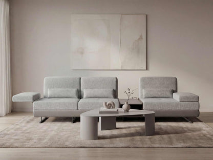 Gray sectional sofa in a modern living room with abstract art on the wall.