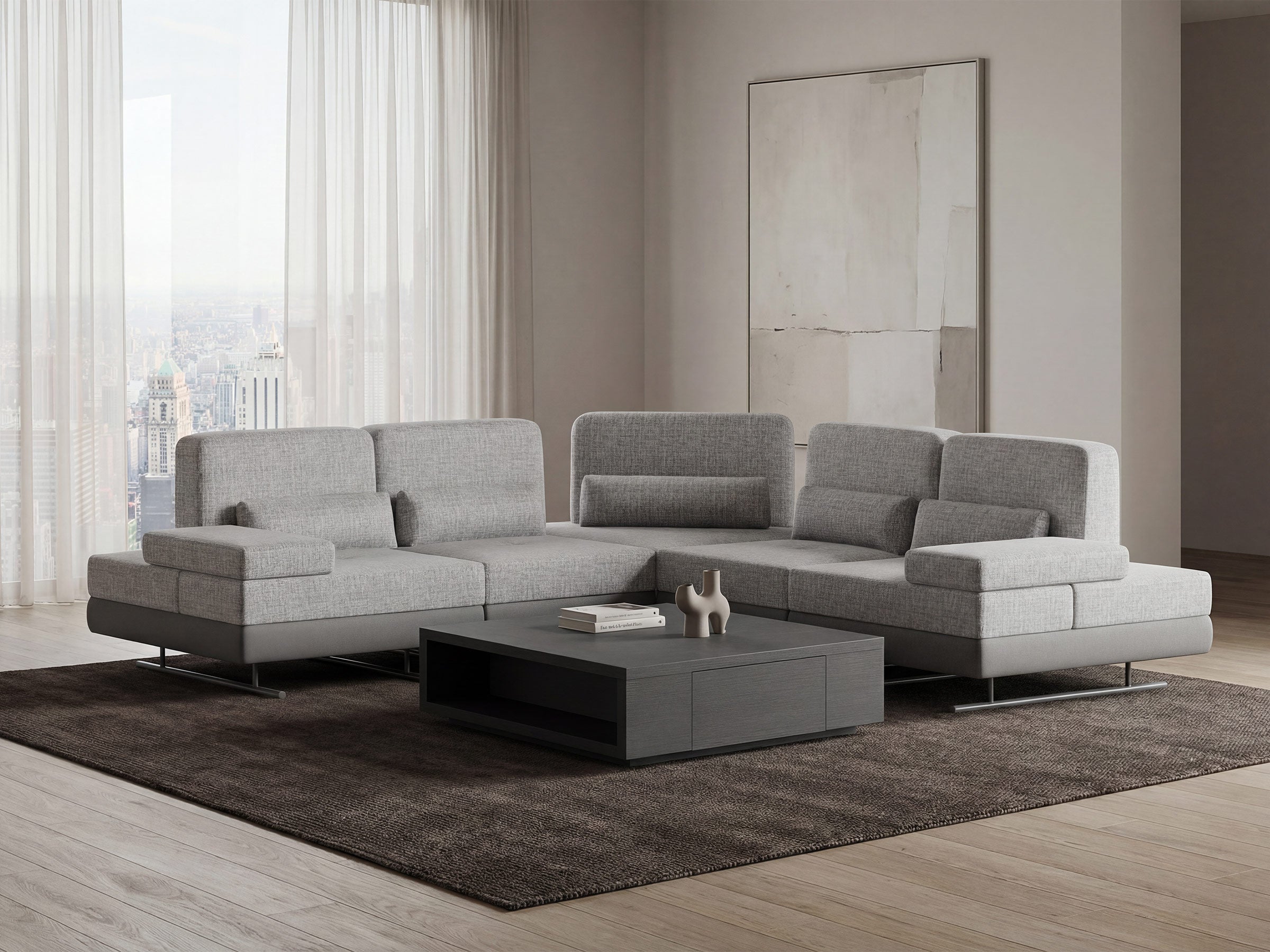 Gray sectional mony sofa in a modern living room with a coffee table and cityscape view.