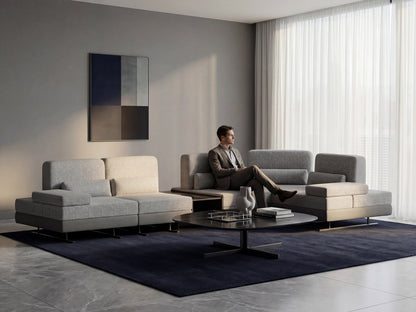 Modern living room with a gray sectional sofa, coffee table, and abstract art on the wall.