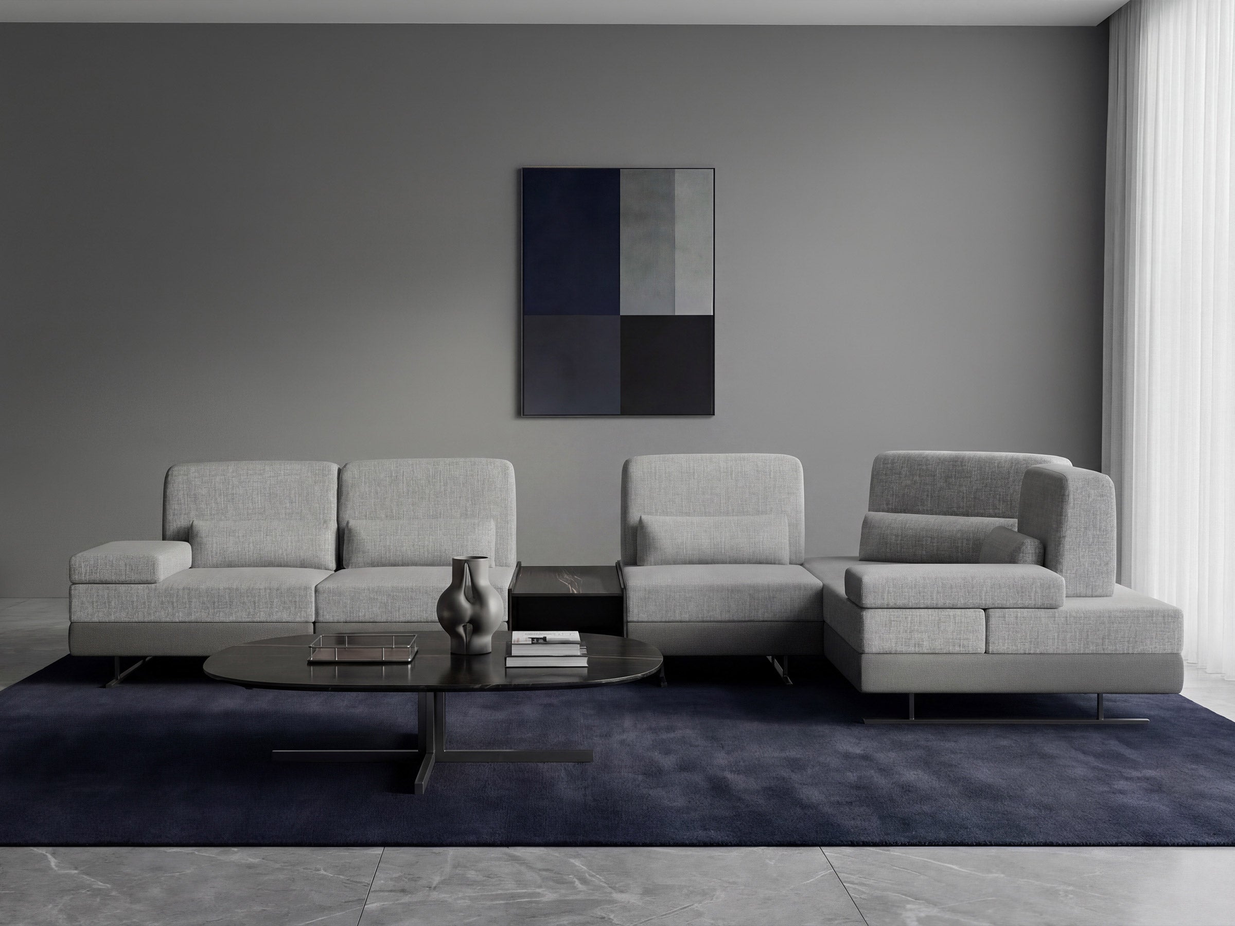 Gray sectional sofa in a modern living room with abstract art on the wall.