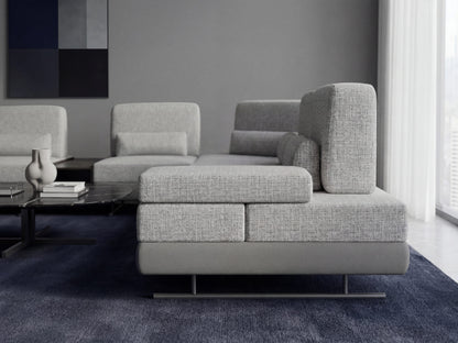 Gray sectional sofa in a modern living room with a abstract painting on the wall.