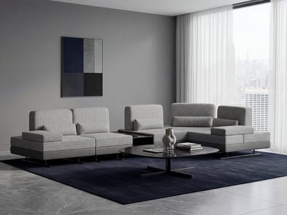 Modern living room with gray sectional sofa, coffee table, and abstract wall art.
