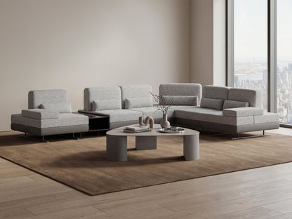 Gray sectional sofa with a coffee table in a modern living room.