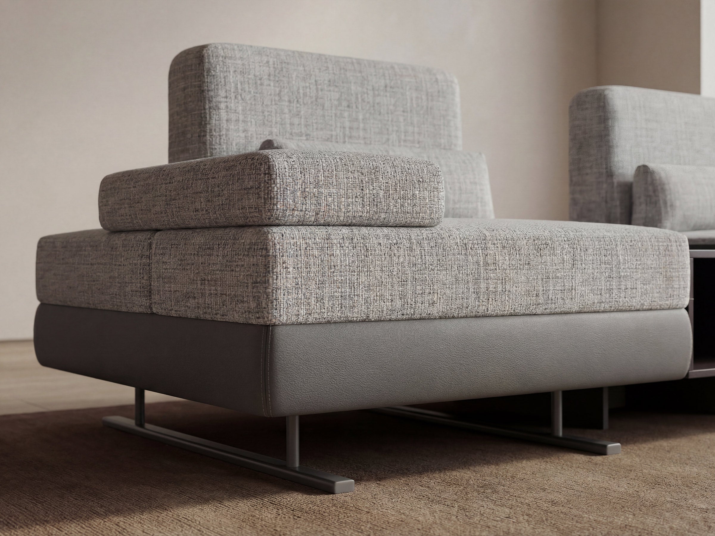 Gray upholstered chair with a textured fabric finish in a minimalistic setting.