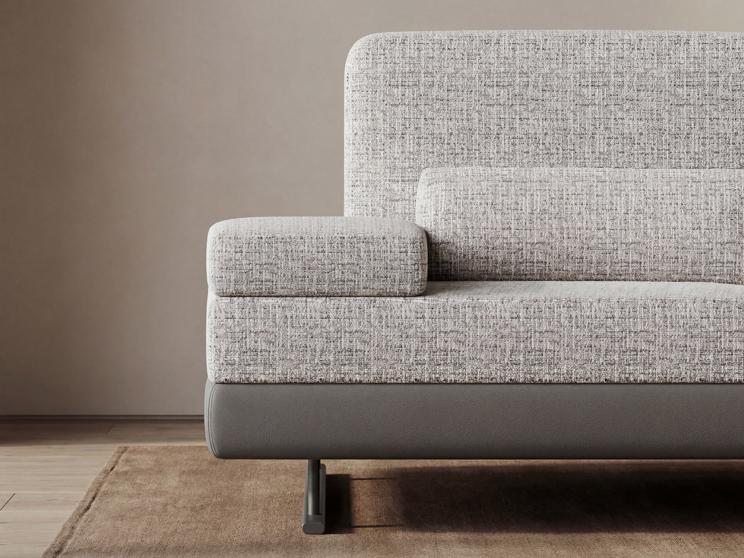 Gray textured sofa against a beige wall