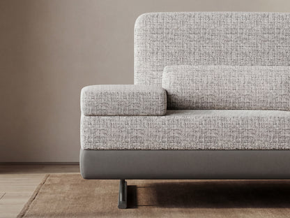 Gray textured sofa against a beige wall