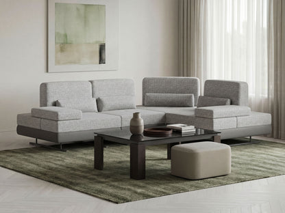Modern living room with a gray sectional sofa, coffee table, and decorative items.