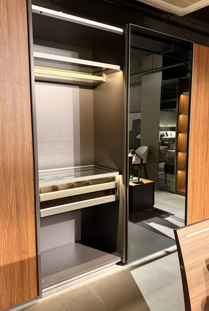 Modern walk-in closet with wooden panels and built-in shelves.