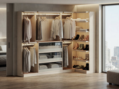 Modern walk-in closet with clothes, shoes, and shelves in a well-lit room.