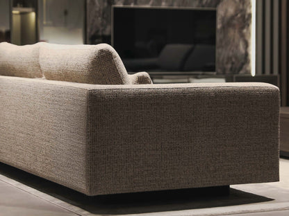 Merlin sofa in a living room setting with a television in the background.