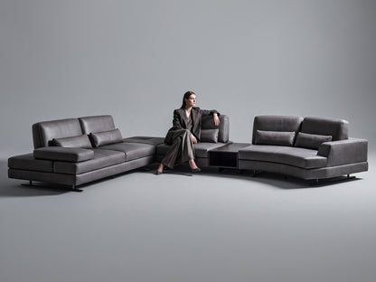 Mony sofa modern dark gray sectional sofa in a minimalist studio setting with a matching chaise lounge on both sides.