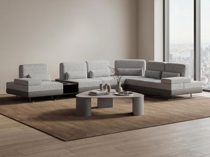 Gray sectional sofa in a modern living room with a coffee table and decor items.